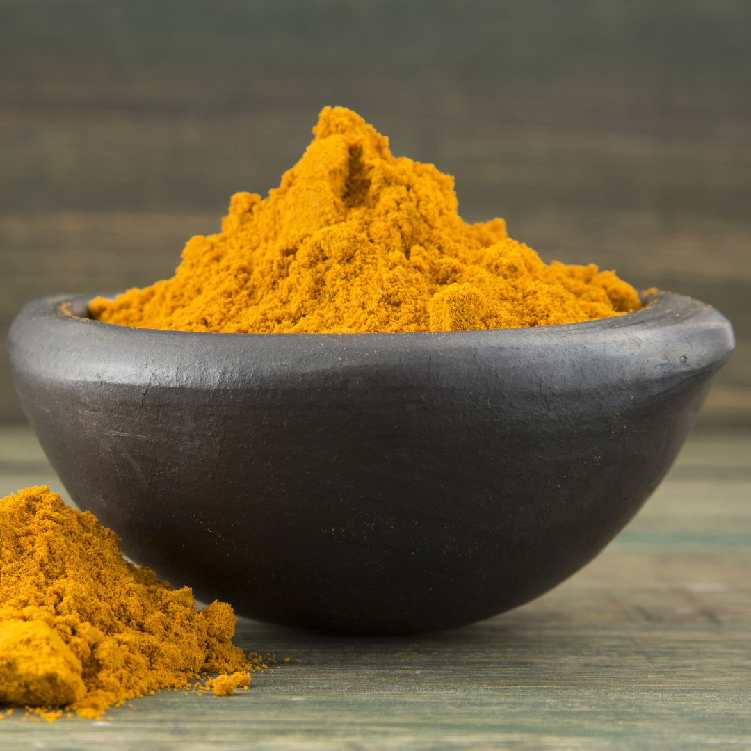 Ground turmeric in a bowl for turmeric mask key ingredient list