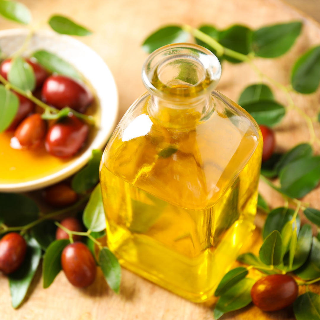 Bottle of Jojoba Seed oil surrounded by Jojoba