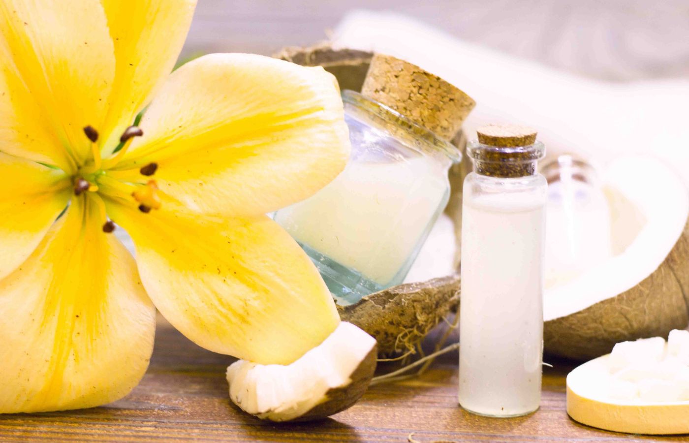 coconut oil in a bottle with a coconut and yellow flower