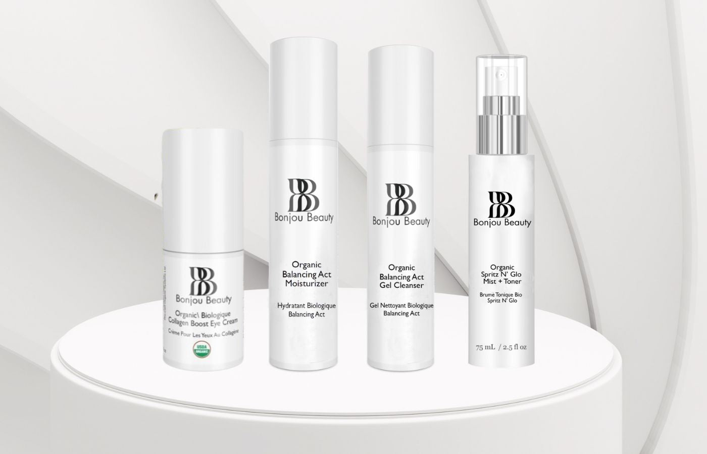 4 Bonjou Beauty skincare product bottles on a white table and white background