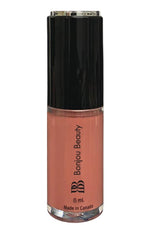 Overnight shade vegan lip gloss on a white background with black cap