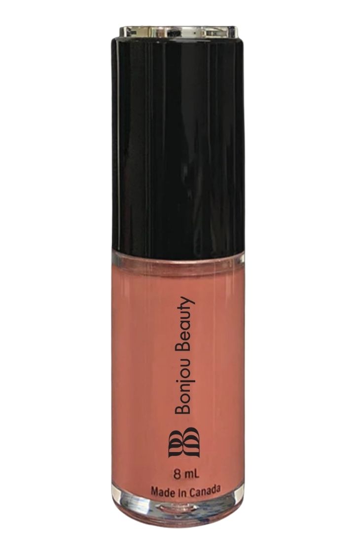 Overnight shade vegan lip gloss on a white background with black cap