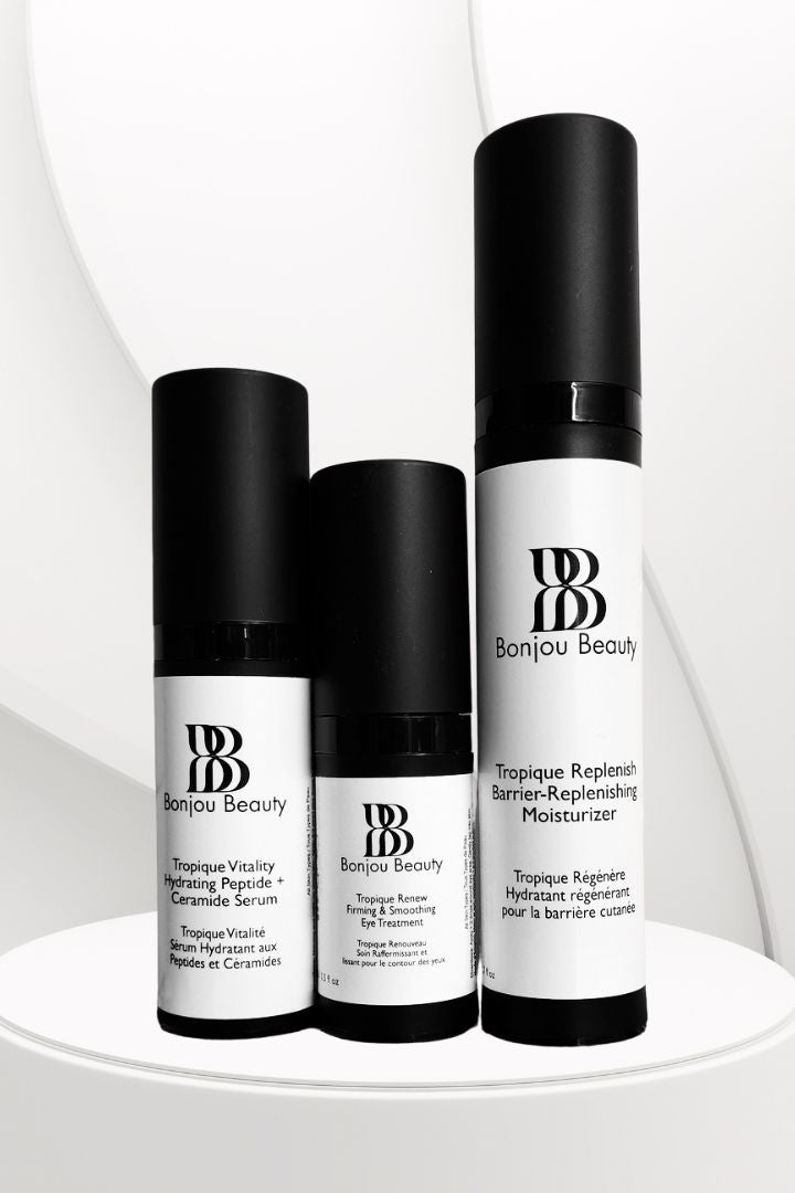 3 Bonjou Beauty skincare products with white and black packaging on a white table and background