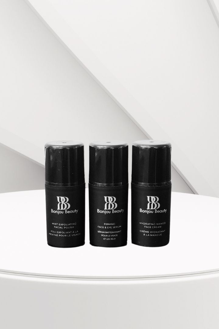 Three black Bonjou Beauty branded skincare bottles on a white surface.