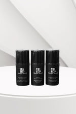 Three black Bonjou Beauty branded skincare bottles on a white surface.