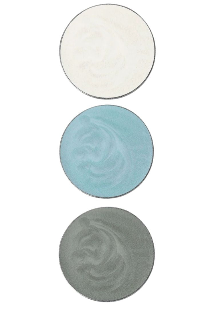 Three circular eyeshadows in white, blue, and gray on a white background