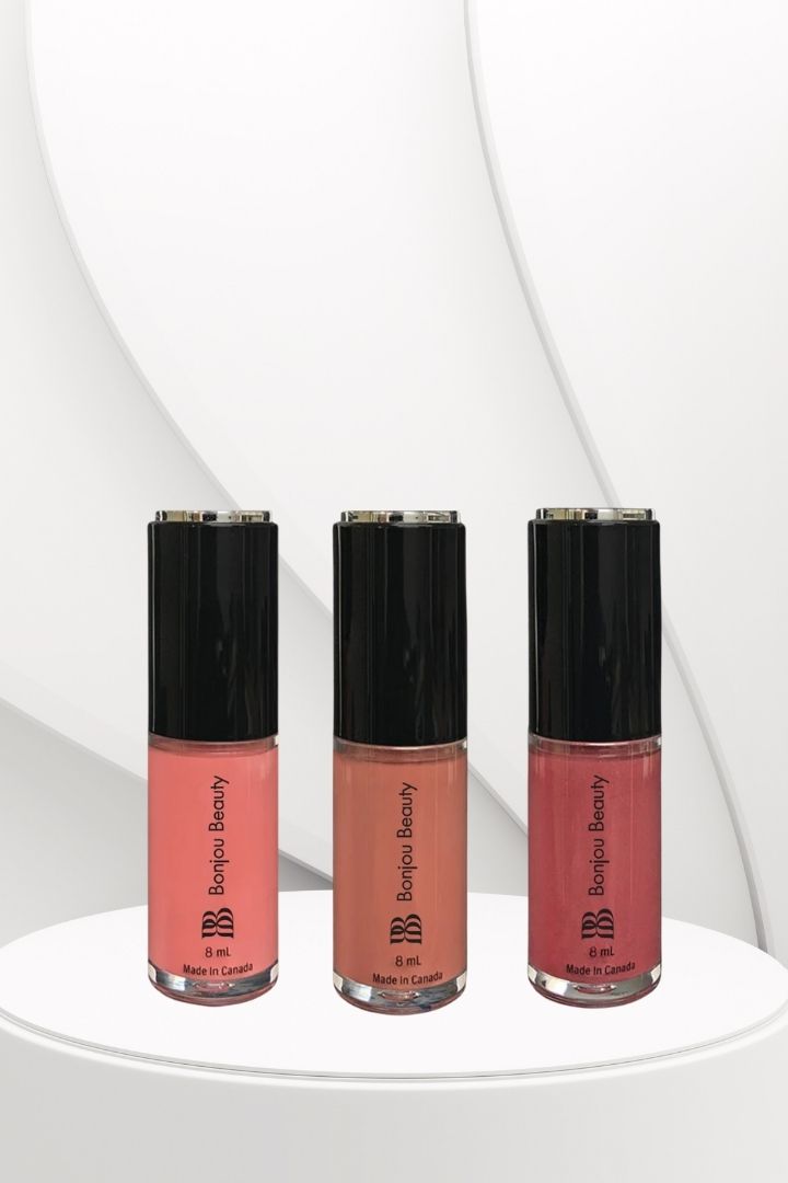 3 Vegan lip glosses on a white table and background