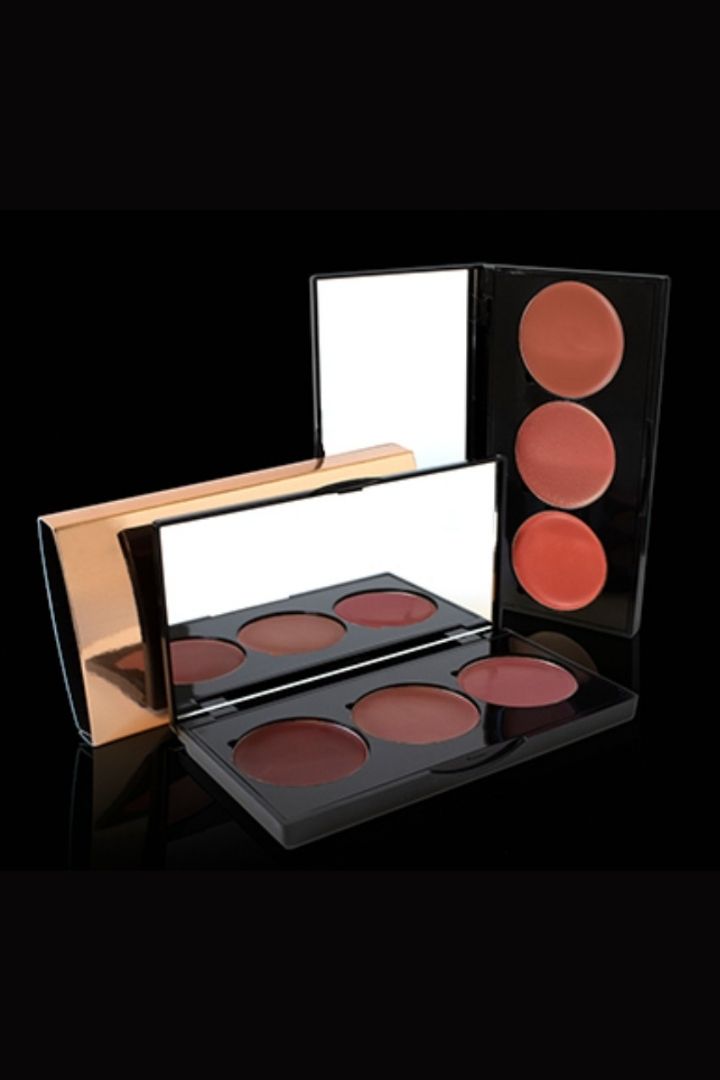 Makeup palette with multiple shades of blush on a black background
