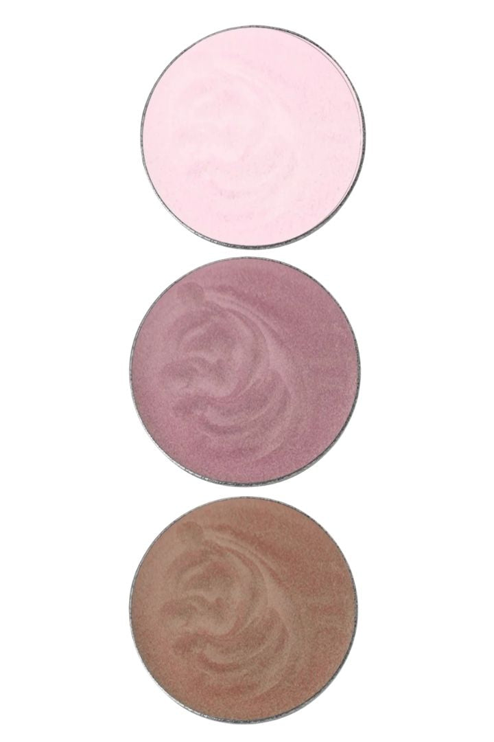 Three round eyeshadow shades in pink, rose, and beige on a white background