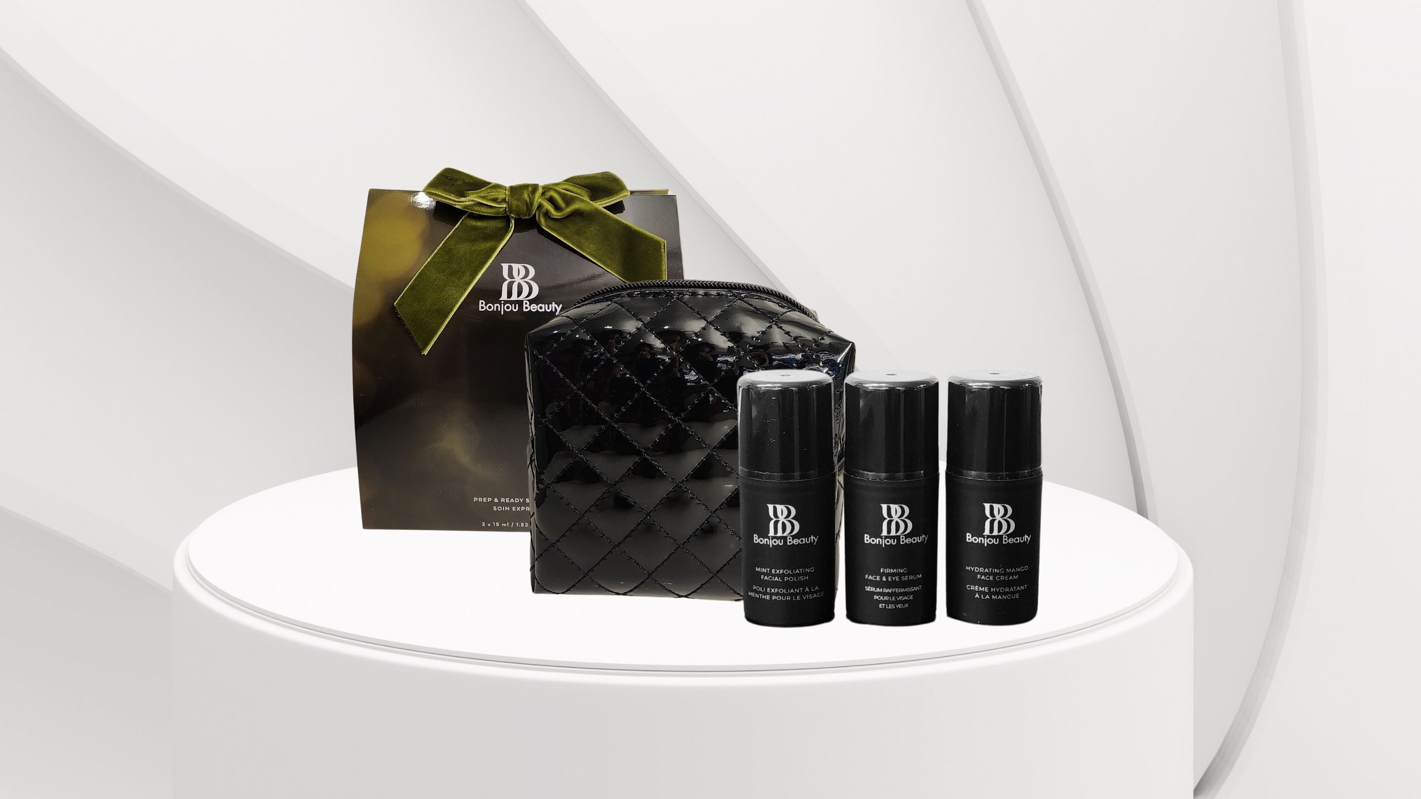 Set of black Bonjou Beauty skincare products with a quilted travel pouch and gift box on a white platform.