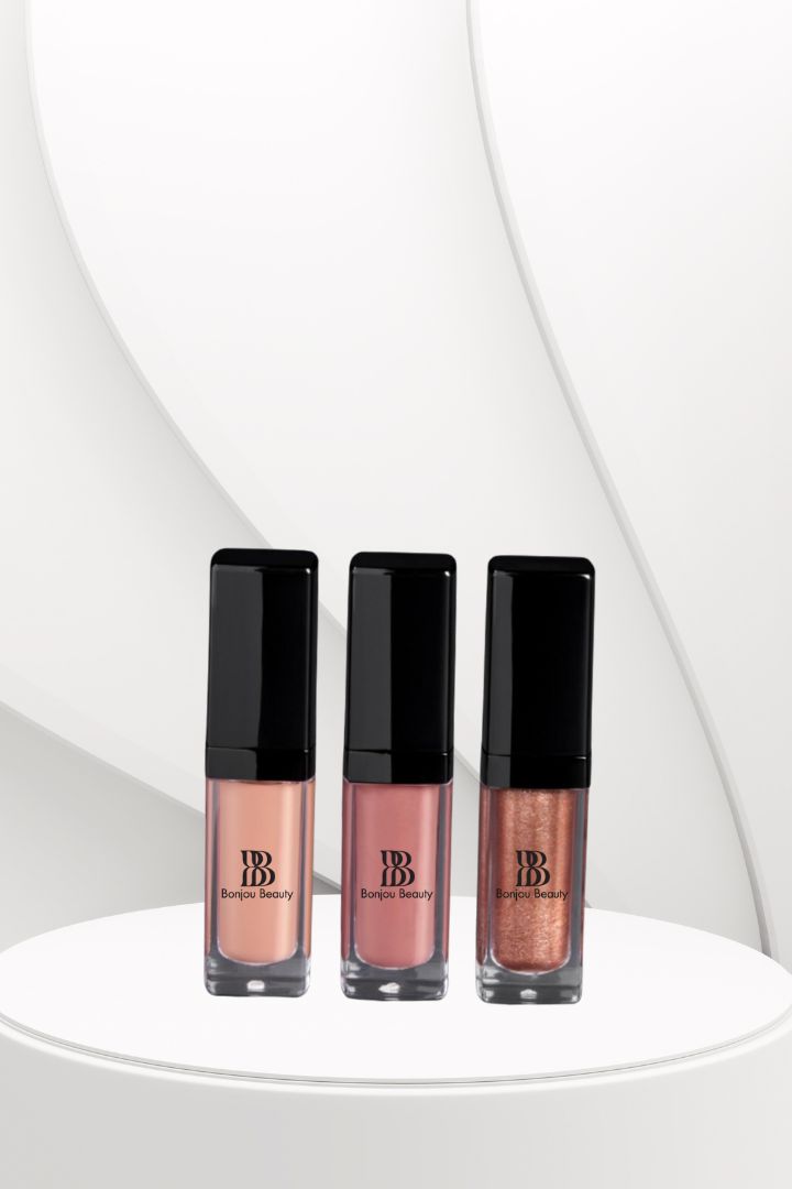 Three lip gloss bottles with black caps on a white background