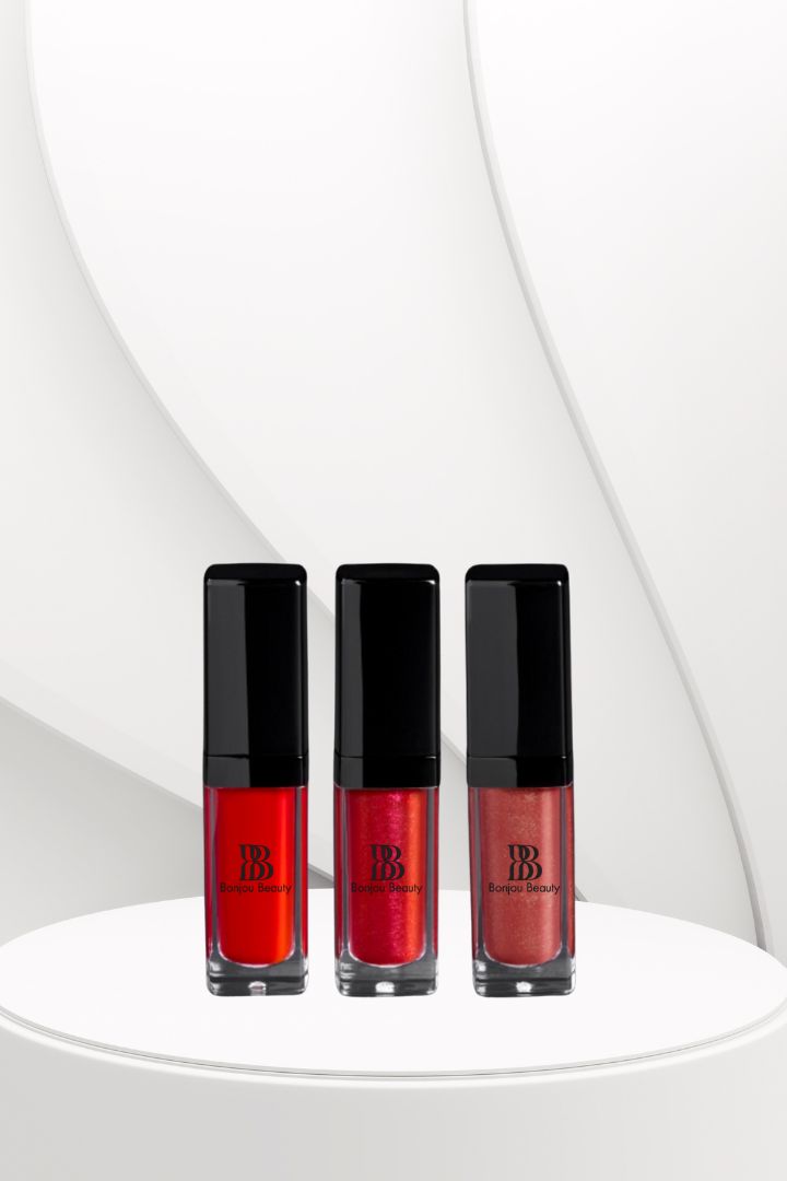 Three red lip glosses with black caps on a white background