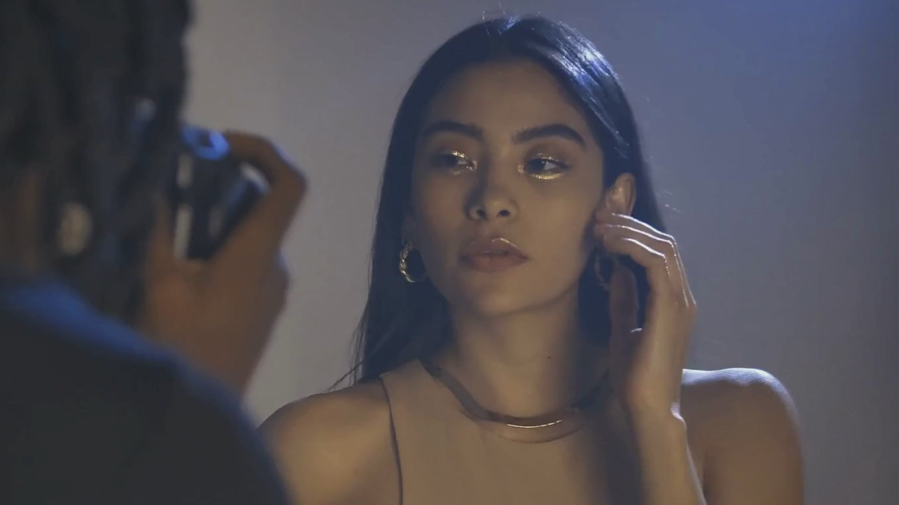 Woman modelling dimaond liquid shimmer around eyes and lips for photoshoot